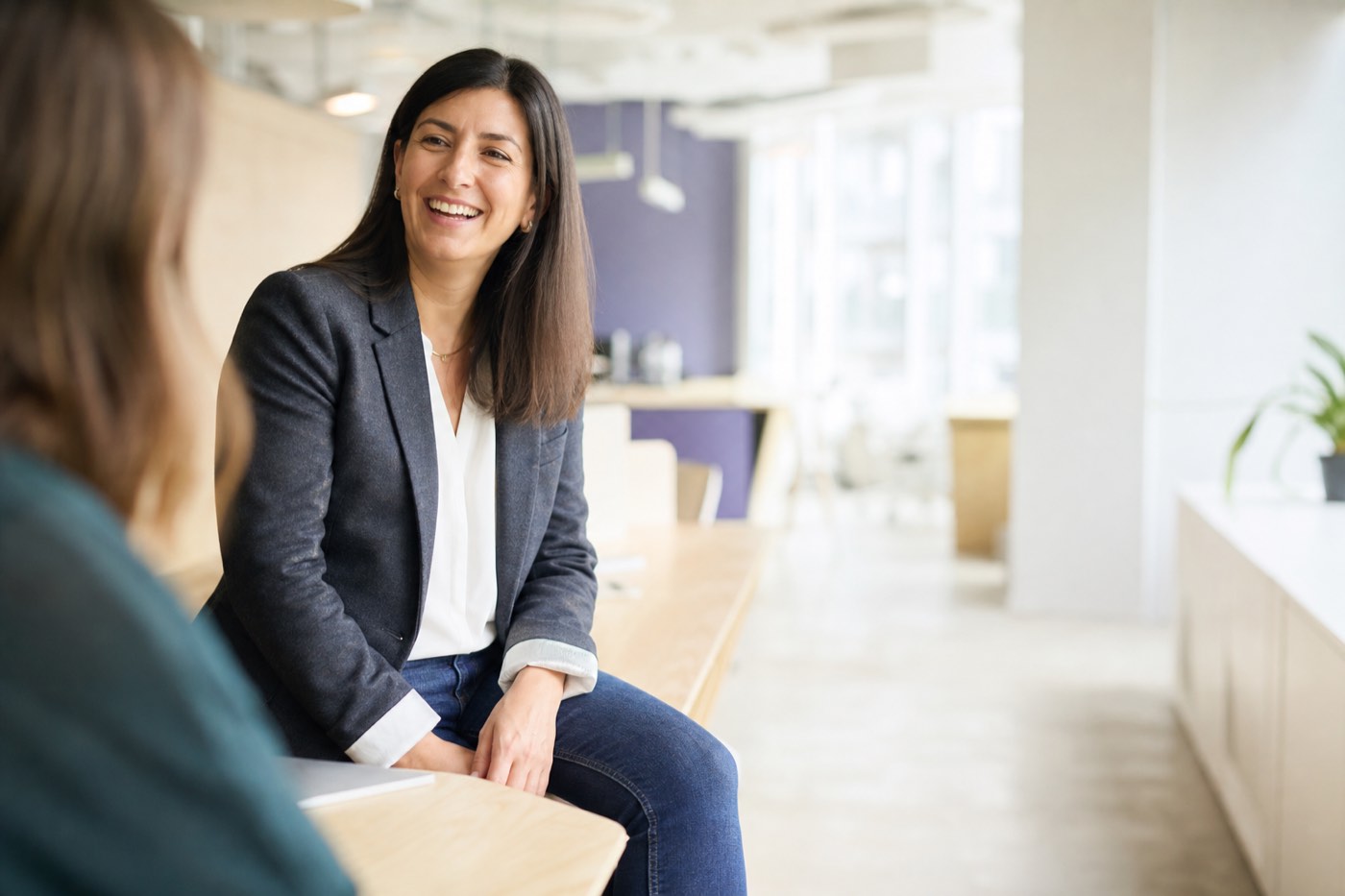 Northwind Health's marketing lead in conversation with a colleague in their office